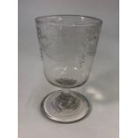 An early 19th century wine glass, bucket bowl etched with swag and ribbon decoration, short plain