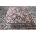 Old Indo-Persian Kashan carpet, the repatring floral lozenge design on mid blue ground, 305 cm  x