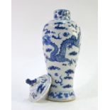 A Chinese blue and white vase with domed cover and animal finial, decorated with confronting four-