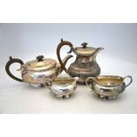 A silver four piece tea service of bulbous oval form, with milled rims and flared foot, composite
