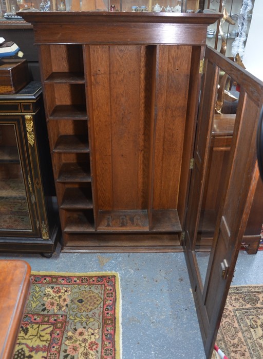 An Arts & Crafts period wall hanging oak gun cabinet, the single door centred by a glazed panel - Image 2 of 4