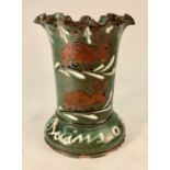A continental tin glazed red earthenware vase with wavy rim, green ground, decorated with rabbits,