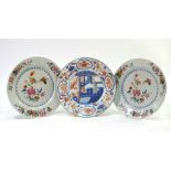 A pair of famille rose plates, each one decorated with natural history designs; together with a