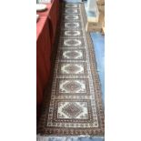 An old Belouch runner, the geometric design on camel and brown ground,  415 cm x 83 cm
