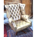 A vintage buttoned tan leather armchair to/w a matching footstool (2)