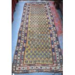 An antique Caucasian runner, the field of repeating geometric designs on dark yellow ground, 285
