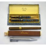 A boxed Burnham of London marbled fountain pen and pencil set, the pen with 14ct nib (little