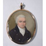 A George III oval portrait miniature on ivory of a gentleman in grey coat, in gilt metal pendant