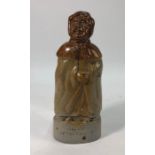 An early 19th century salt glaze flask in the form of an old lady in a hooded cloak, impressed '