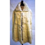 A vintage white coney fur lady's cape with floral cream silk satin lining