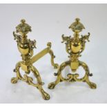 A good quality brass pair of chenets/fire dogs, cast with foliage and dolphins, 37 cm high