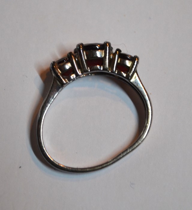 A three-stone garnet ring, set white metal stamped 925 (shank misshapen) - Image 2 of 2