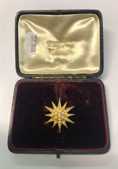 A 19th century 18ct yellow gold star burst pendant set overall with pearls, the centre with single