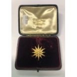 A 19th century 18ct yellow gold star burst pendant set overall with pearls, the centre with single