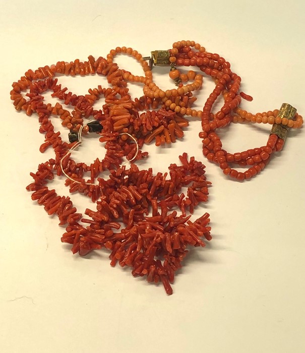 Three Victorian coral jewellery items including triple row bracelet on gilt metal foliate engraved