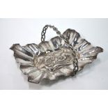 An Arts & Crafts style rectangular dish embossed with a dragon within a hammered and crenelated rim,
