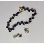 A lapis lazuli bead and yellow metal bead bracelet, stamped 750 to/w a pair of 9ct yellow gold