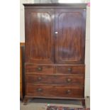 A 19th century mahogany wardrobe (converted from a linen press) the pair of panelled doors enclosing