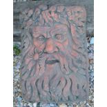 A cast terracotta coloured garden plaque of Neptune