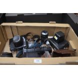 A box of assorted cameras to include Praktica, Zenit, a Movikon 8 cine camera, various lens and