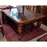 A 19th century extending dining table, the rounded rectangular top with moulded edge and single