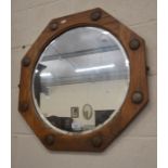 An octagonal oak framed bevelled edge wall mirror