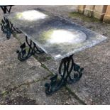 A weathered rectangular marble top cast iron framed garden table