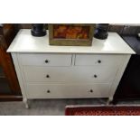 A Laura Ashley white painted chest of two short over two long drawers raised on shaped supports