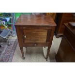 A Victorian mahogany night stand, with slide over a cupboard and drawer, raised on turned legs to