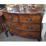 A 19th century mahogany bowfront chest of two short over two long drawers raised on short turned