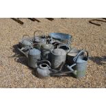 Twelve various galvanized items including watering cans, a pail and two planters (12)