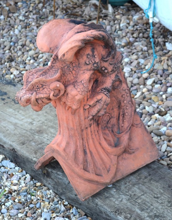 A terracotta coloured dragon ridge tile