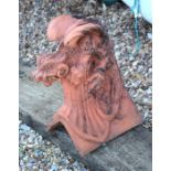 A terracotta coloured dragon ridge tile