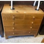A 1950's oak chest of two short over three long chests of drawers
