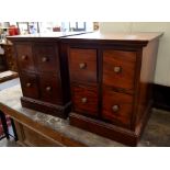 A pair of hardwood four drawer bedside cabinets