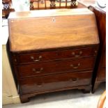 A Georgian mahogany fall front bureau with fitted interior over three graduating drawers raised on