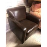 A modern Art Deco style brown leather armchair