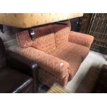 A two seat sofa with geometric design covers - a/f