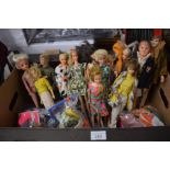 A box containing over 15 vintage Sindy, Barbie, Ken, Paul dolls, c/w bags of clothing and