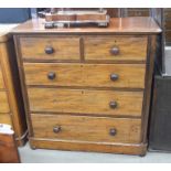 A Victorian mahogany chest of two short over three long drawers with turned pulls, one missing,