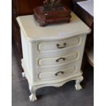 WITHDRAWN A French painted bedside chest with three drawers raised on carved supports with ball