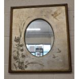 An oval mirror in gilt frame decorated with birds, butterflies and foliate