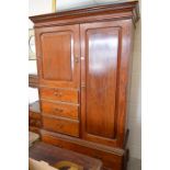 A mahogany compactum with panelled doors and four drawers, raised on bracket feet