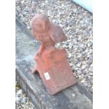 A terracotta coloured owl ridge tile