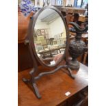 A strung mahogany oval dressing table swing mirror