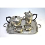 A Liberty 'Tudric' hammered pewter four piece tea service, 01536, on matching 'Warric' 6092 tray (