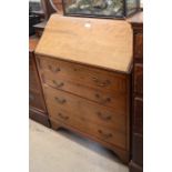 An Edwardian inlaid mahogany fall front bureau with fitted interior over four long drawers, raised