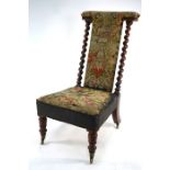 A Victorian walnut framed tapestry covered prie dieu chair