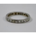 A white metal diamond set eternity ring