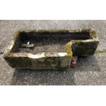 An antique weathered cut stone sink/planter,